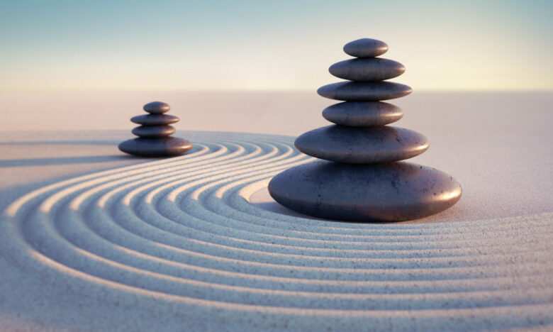 Japanese ZEN garden with textured sand waves and stack of stones